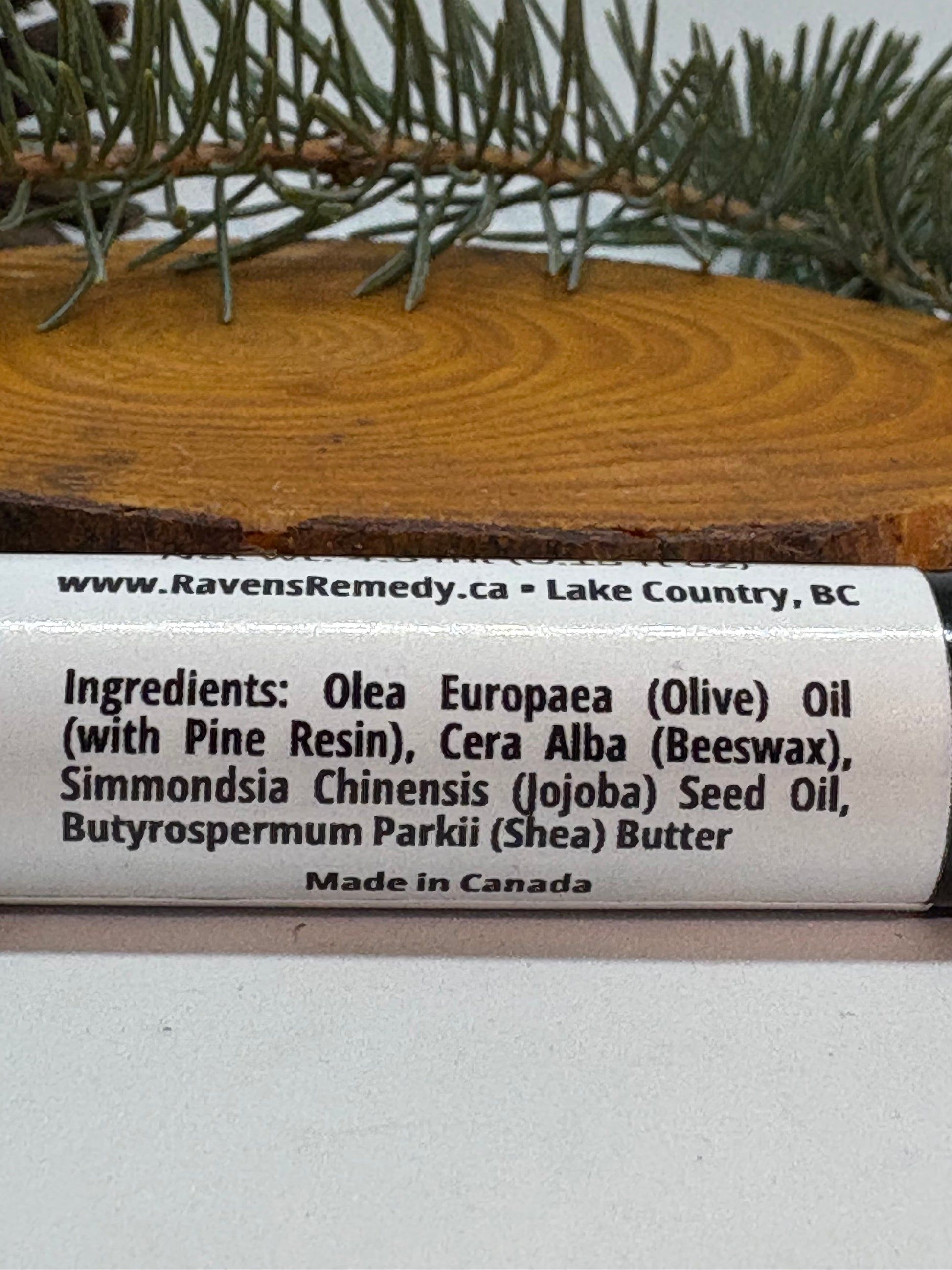 Close-up of the ingredients label on Raven's Remedy Pine Pitch Lip Balm.